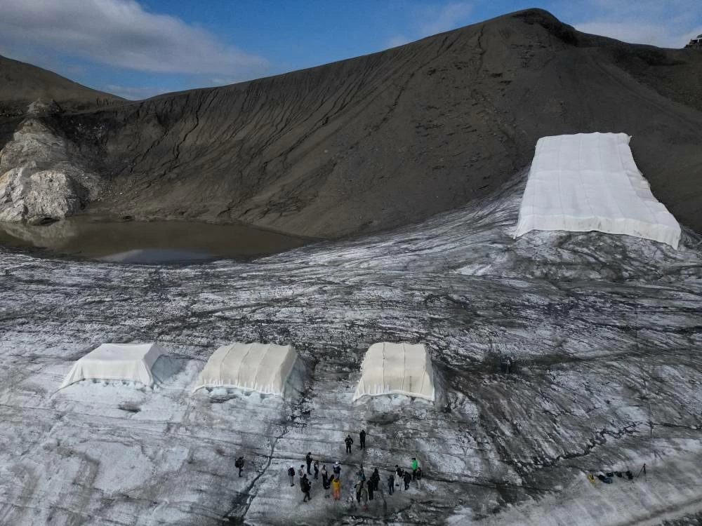 A drone view shows a snow protection test site covered with sheep wool material during a press conference presenting the results of the "Keep It Wool" glacier protection experiment in Les Diablerets, Switzerland, September 2, 2026. (Reuters)