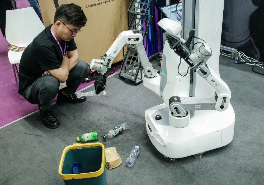 A man looks at the X Square Robot operating at the FAIR Plus robotics supply chain conference in Shenzhen, Guangdong province, China, April 23, 2026. (Reuters)