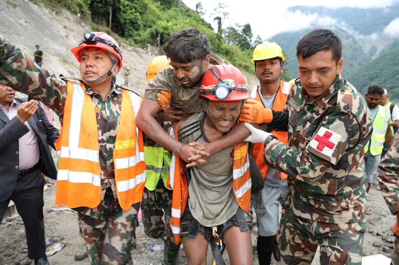 A man who survived is carried by members of a search and rescue team after they rescued alive two people who had been trapped inside a tunnel at the Trishuli-3A Hydropower Project following devastating floods and mudslides that struck the Bhotekoshi River in Rasuwa, Nepal, September 4, 2026. Nepal Army/Handout via REUTERS.