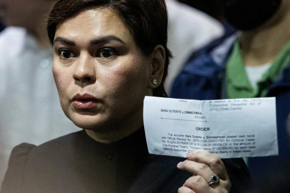 Philippine Vice President Sara Duterte shows members of the media a court order confirming she posted bail at the Quezon City Regional Trial Court, a day after a court ordered her arrest, in Quezon City, Philippines, September 5, 2026. (Reuters)