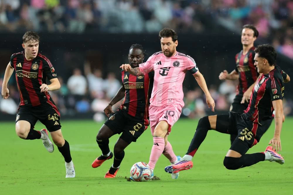Inter Miami forward Lionel Messi (10) dribbles the ball against Atlanta United defender Tomas Jacob (55), midfielder Tristan Muyumba (8) and midfielder Santiago Pita (40) during the first half at Nu Stadium. Reuters