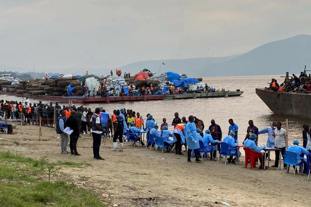 File photo: Passengers who disembarked from a boat intercepted by health authorities wait to be tested, in Kinshasa, Democratic Republic of the Congo, August 6, 2026. (Reuters)
