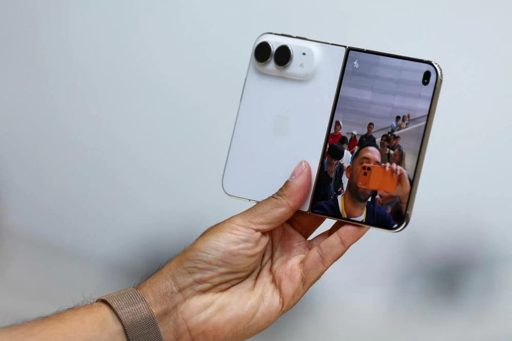A person holds the new foldable iPhone Duo during Apple's event at the Steve Jobs Theater in Cupertino, California, U.S. September 9, 2026. Picture credit: Reuters