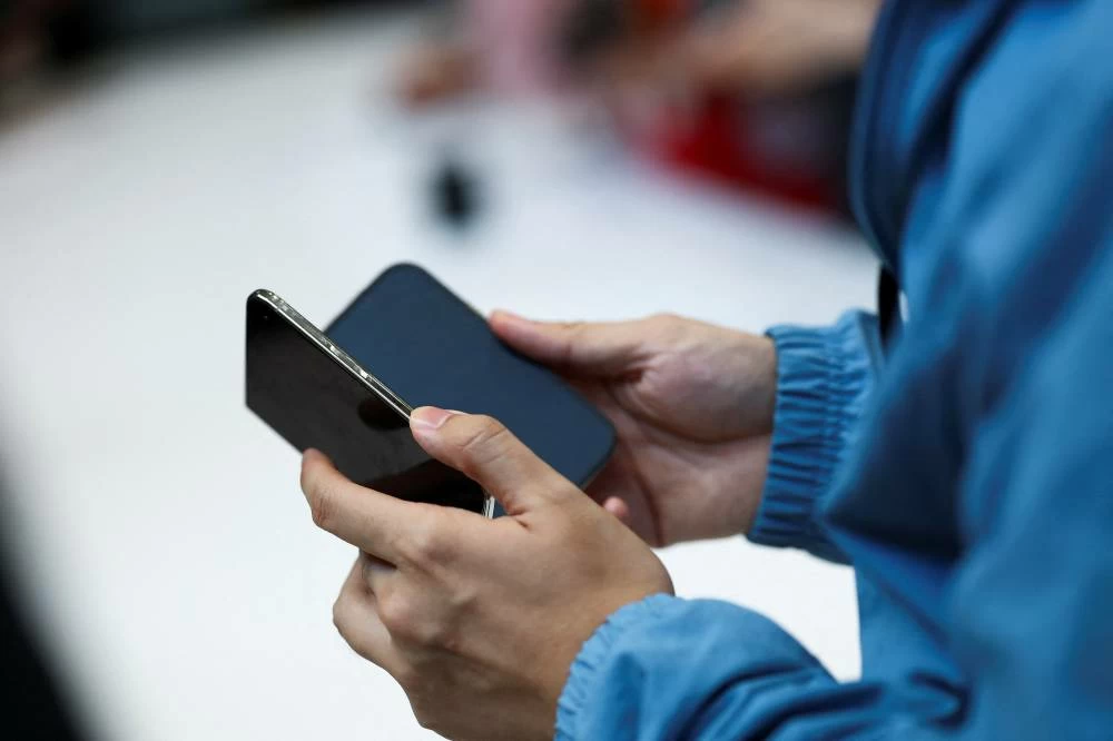 A person holds the new foldable iPhone Duo during Apple's event at the Steve Jobs Theater in Cupertino, California, U.S. September 9, 2026. Picture credit: Reuters