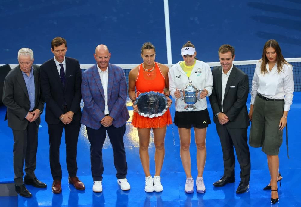 Kazakhstan's Elena Rybakina poses with the winners trophy as Belarus' Aryna Sabalenka poses with the runner-up trophy after their final match with former tennis player Maria Sharapova and President of the United States Tennis Association Brian Vahaly REUTERS