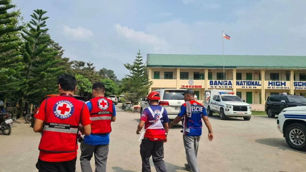 Emergency personnel walk at a site of a deadly shooting at a school in Banga, South Cotabato, Philippines, September 18, 2026. (Philippine Red Cross/Handout via Reuters)