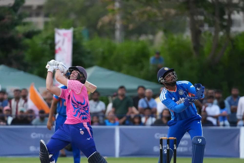 India's wicketkeeper Samson, right, and Japan's Kendel Kadowaki-Fleming, look for the ball hit by Kadowaki-Fleming during the Suzuki Cup T20 cricket match in Sano, Japan, Tuesday, Sept. 22, 2026, marking 75 years of diplomatic relations between the two countries. (AP Photo/Tomohiro Ohsumi)