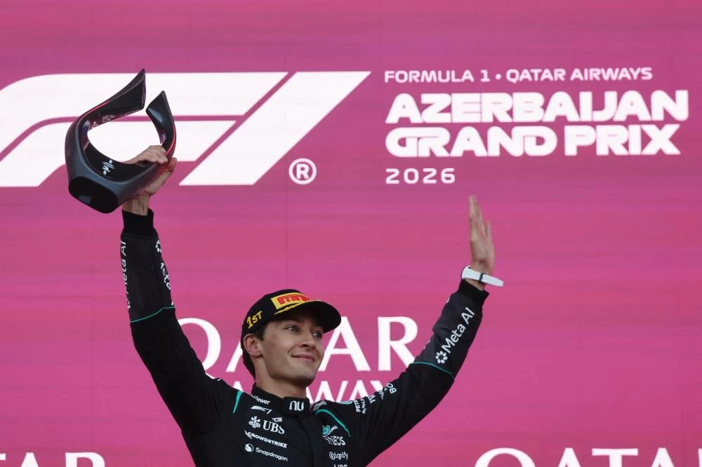 Mercedes' George Russell celebrates on the podium after winning the race in Baku. (Reuters)