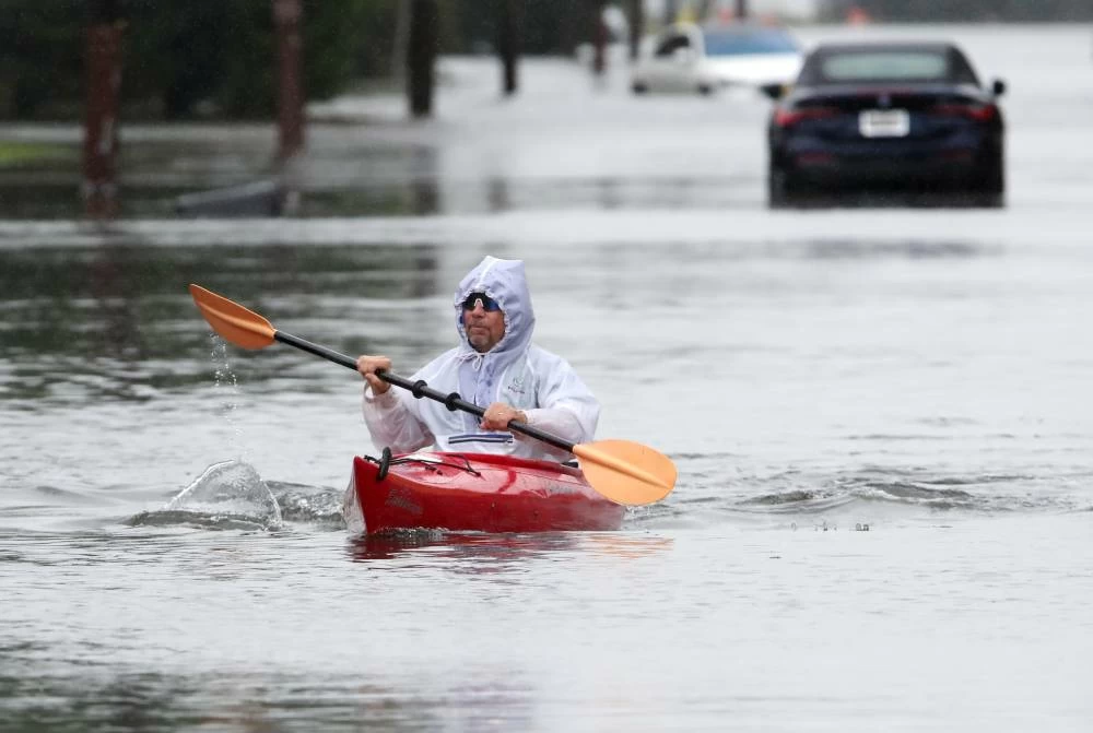 Ted Friedli kayaks his way through a flooded section of Florence Ave. duringa Nor-easter in Long Branch, N.J. AP