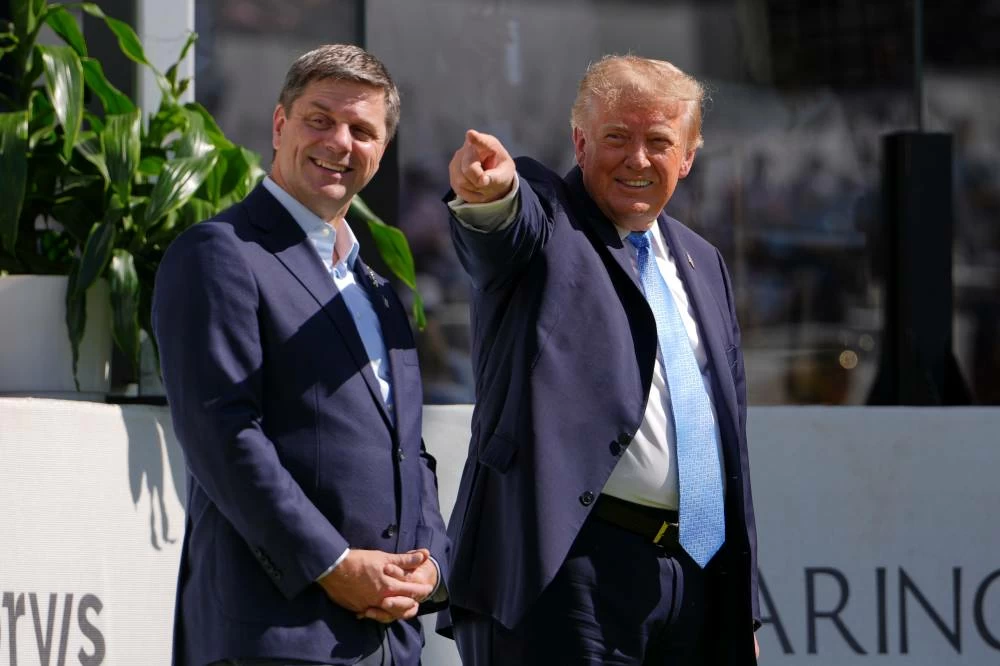 President Donald Trump, right, stands with PGA CEO Brian Rolapp at the Presidents Cup golf tournament at Medinah Country Club, Sunday, Sept. 27, 2026, in Medinah, Ill. AP