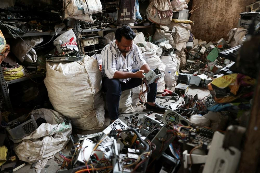 FILE PHOTO: A man recycles electronic waste, or e-waste, from computer power supplies at a scrap yard in Ahmedabad, India
(Reutes)