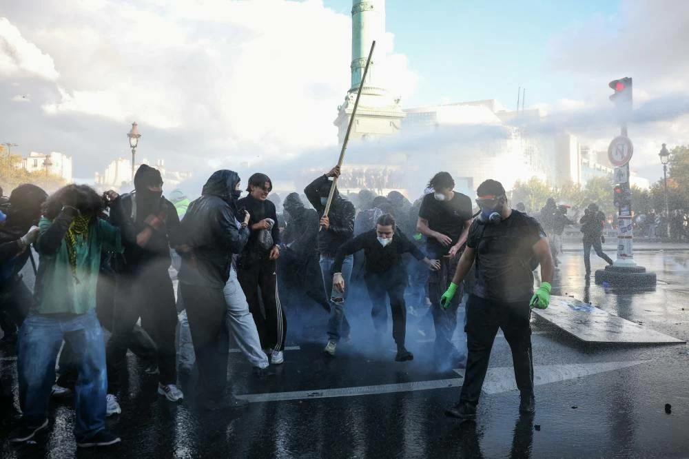 A water cannon sprays demonstrators during nationwide protests in Paris, France, October 8, 2026, to demand better school conditions. REUTERS