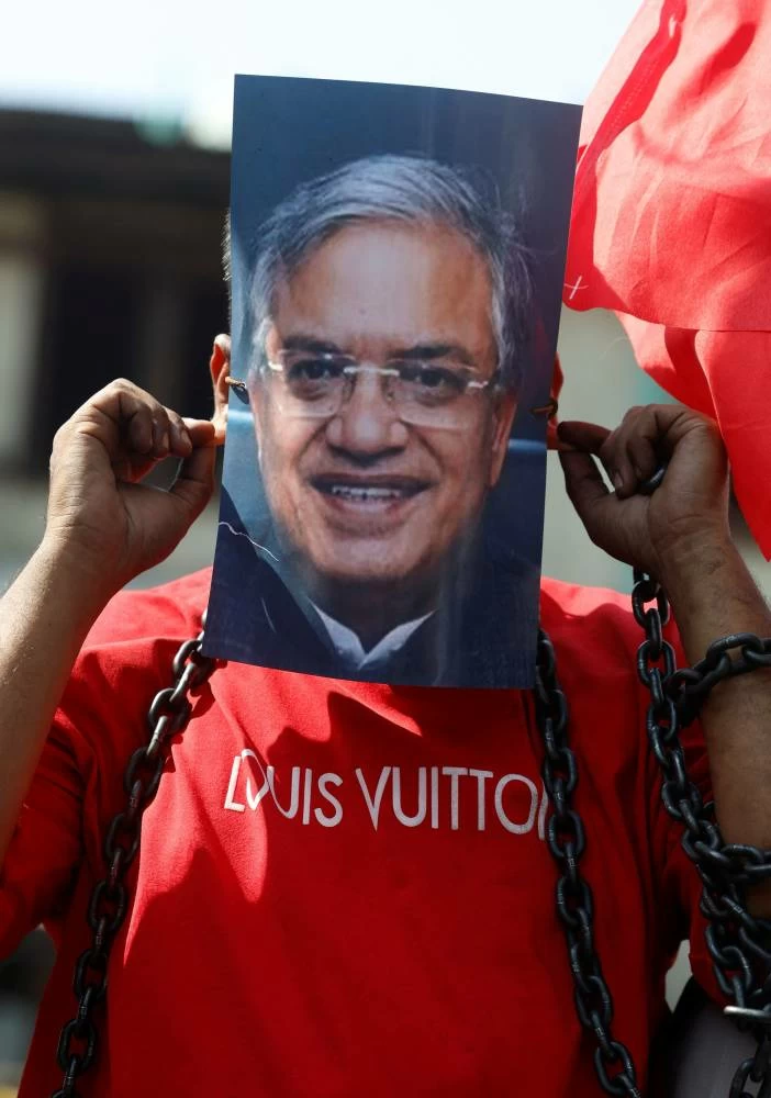 A protester wearing a mask depicting Chief Election Commissioner Gyanesh Kumar participates in a demonstration organised by opposition parties demanding his resignation at the Congress office in Srinagar, Indian Kashmir, October 10, 2026. (Reuters)