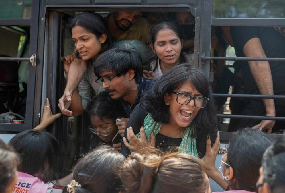 Protesters are detained by security personnel during a protest by the Cockroach Janta Party (CJP) seeking the resignation of India's Chief Election Commissioner Gyanesh Kumar, near the protest site in New Delhi, India, October 10, 2026. (Reuters)