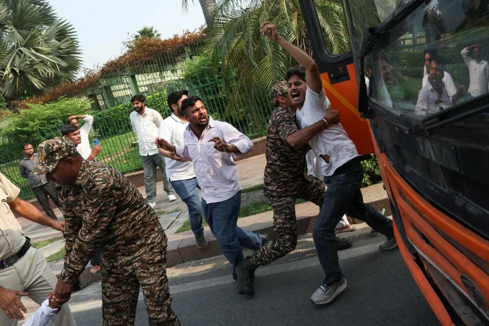 Protesters react as they are detained by security personnel during a protest seeking the resignation of India's Chief Election Commissioner, Gyanesh Kumar, in New Delhi, India, October 13, 2026. REUTERS/Priyanshu Singh