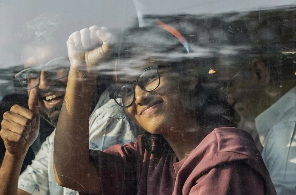 All India Students' Association (AISA) President Neha Bora raises her fist inside a bus, as opposition parties march to the Supreme Court in protest against a controversial revision of voter lists that has sparked days of unrest, in New Delhi, India, October 12, 2026. (Reuters)