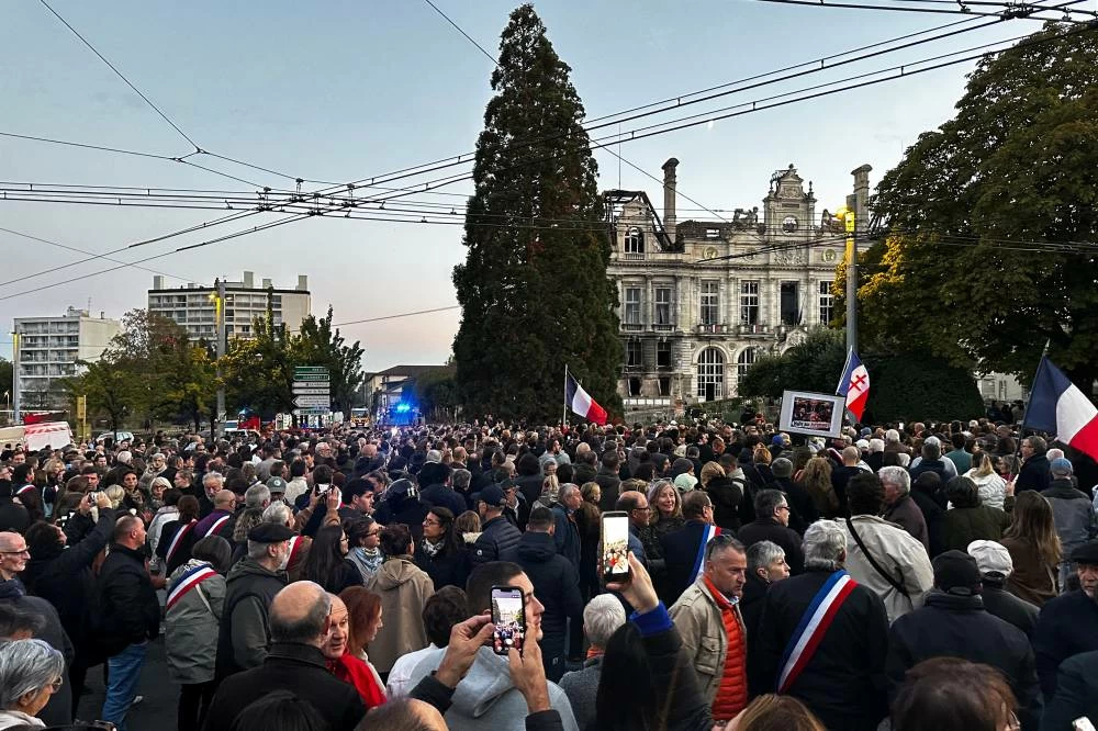 Residents gather during a protest following a fire at the town hall in Limoges, France, October 18, 2026.  REUTERS