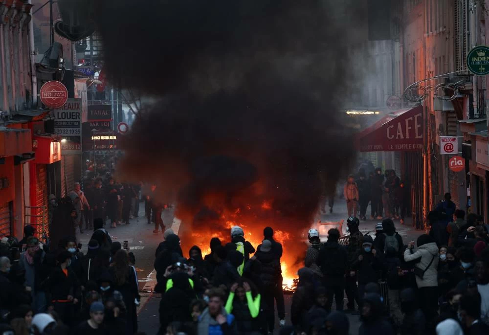 Flames and smoke rise, the day after a national day of demonstrations against the cost of living and rising fuel prices, in Paris, France, October 18, 2026. REUTERS