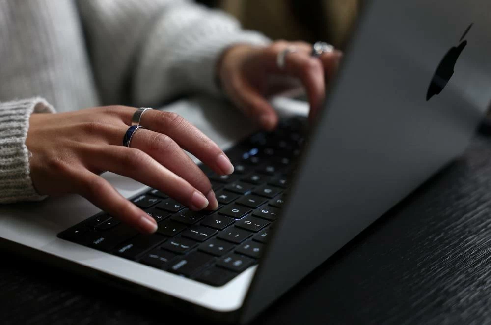 A person works on their laptop at a cafe in London, Britain, October 21, 2026. Government websites across Europe went dark on Wednesday as operators raced to patch two critical vulnerabilities in PHP, one of the most widely used programming languages on the web. Picture credit: Reuters