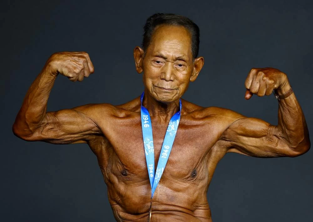 Japan's Toshisuke Kanazawa, 90, poses with his participation medal after competing at the IFBB World Fitness Championships in Santa Susanna, Spain, on October 30, 2026. Kanazawa took on rivals decades younger in the masters category, showcasing his enduring passion for bodybuilding. (Reuters)