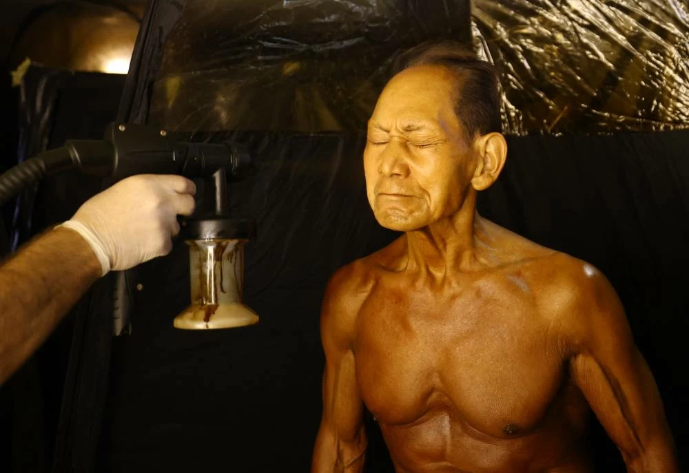Toshisuke Kanazawa, 90, receives a spray tan ahead of the IFBB World Fitness Championships in Santa Susanna, Spain, on October 30, 2026. (Reuters)